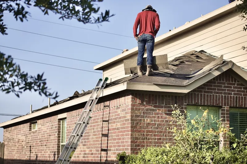 Professional roofer working on a residential roof in Willamette